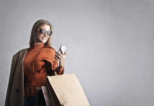 woman wearing a blouse with a shopping bag