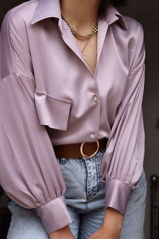 a woman wearing a silk satin blouse long sleeves and buttons
